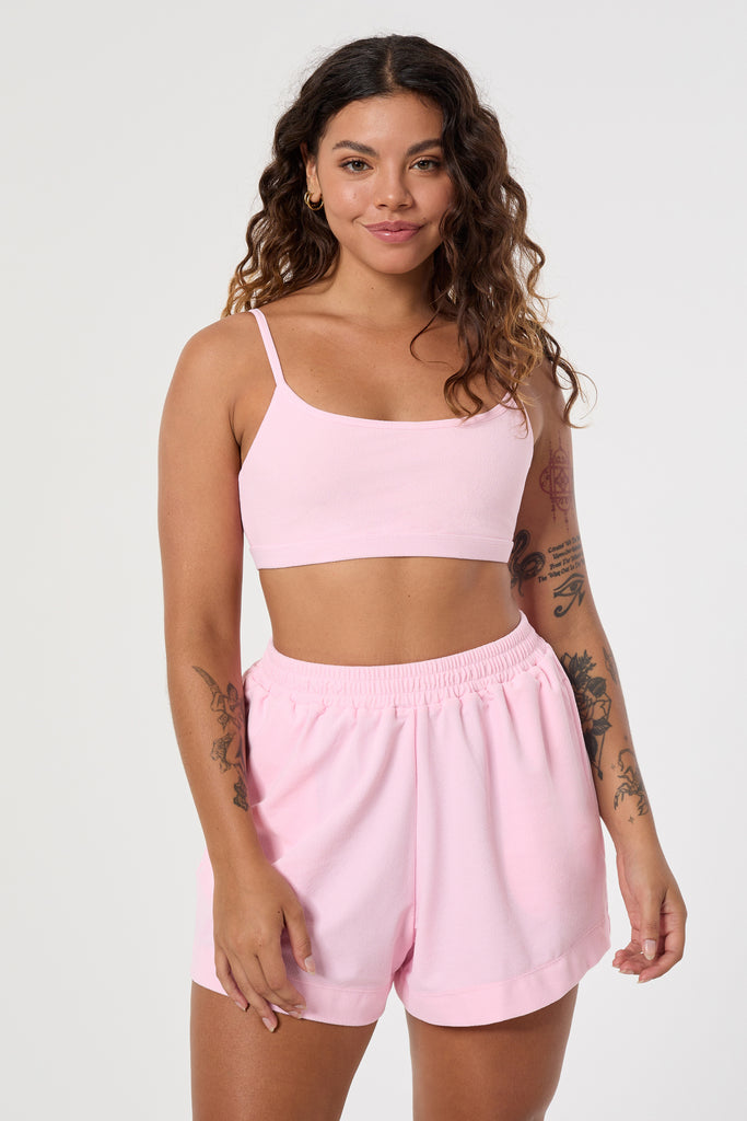 Light pink boxer shorts made from recycled breathable technical terry fabric, designed with an elastic waistband and pockets for ultimate comfort