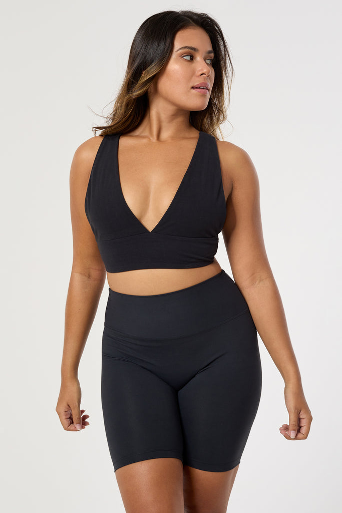 Black deep V-neck low-impact support with a seamless fit, removable padding for all-day comfort and style.