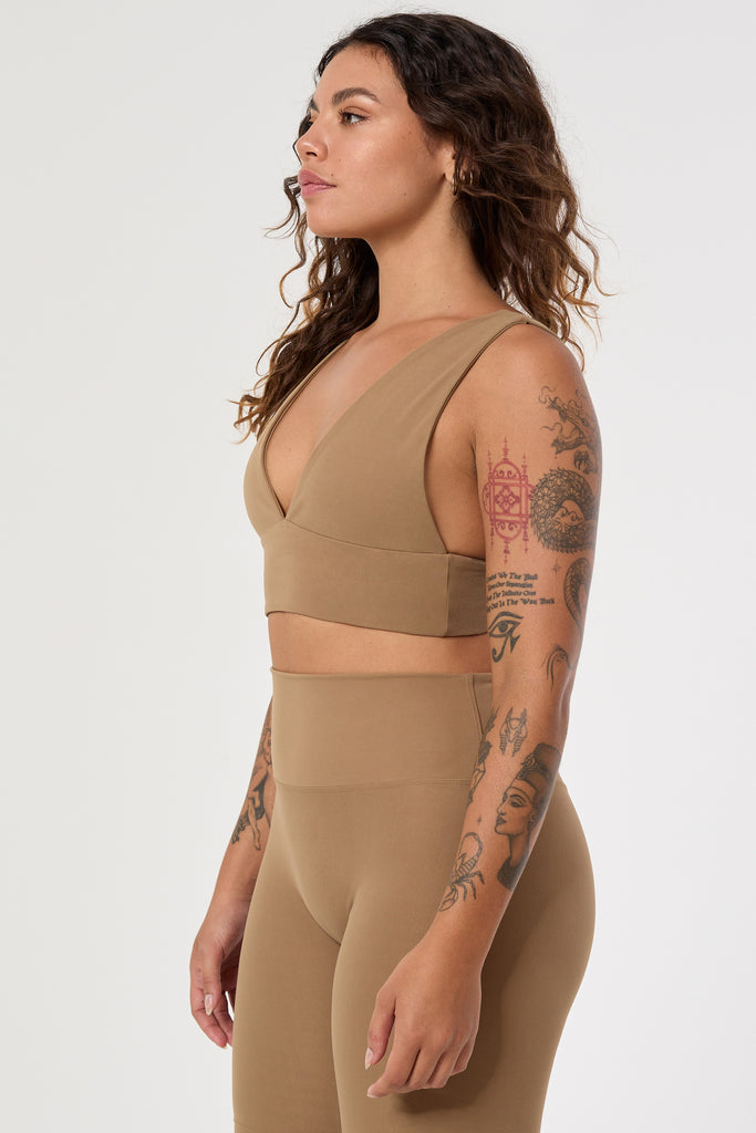 Light brown deep V-neck low-impact support with a seamless fit, removable padding for all-day comfort and style side view