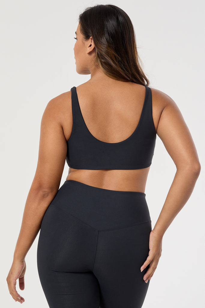 Black two in one reversible sports bra, medium-impact support with seamless fit, under-bust support, and removable padding back view