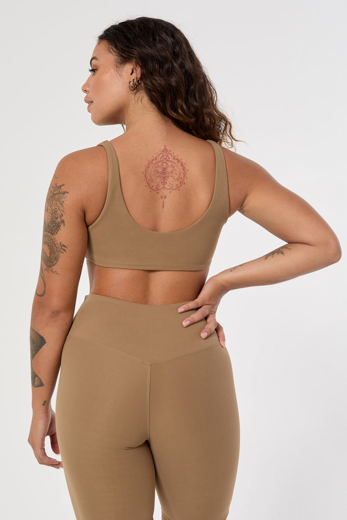 Light brown two in one reversible sports bra, medium-impact support with seamless fit, under-bust support, and removable padding back view