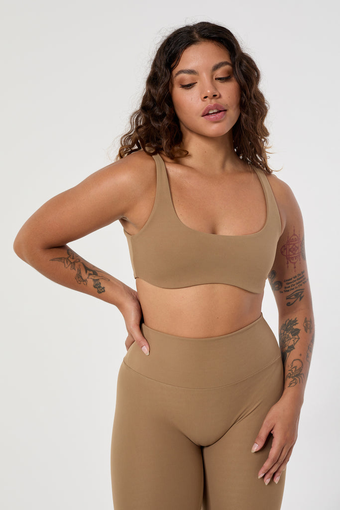 Light brown two in one reversible sports bra, medium-impact support with seamless fit, under-bust support, and removable padding