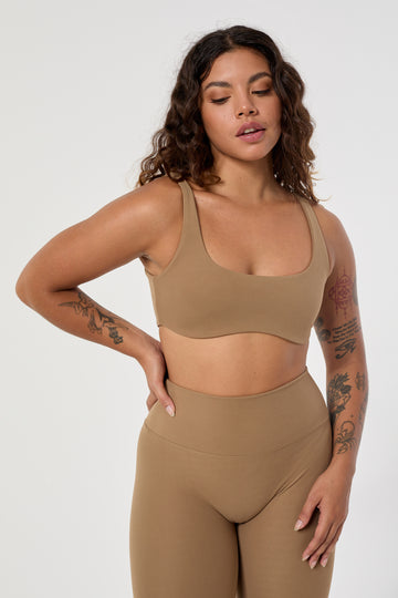 Light brown two in one reversible sports bra, medium-impact support with seamless fit, under-bust support, and removable padding