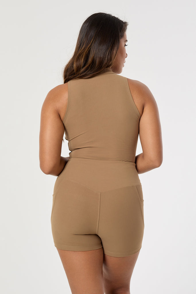 Cute light brown shorts: mid-high waisted with side pockets, V-shaped back seam, squat proof, no front seam, and double-layered waistband ,back view