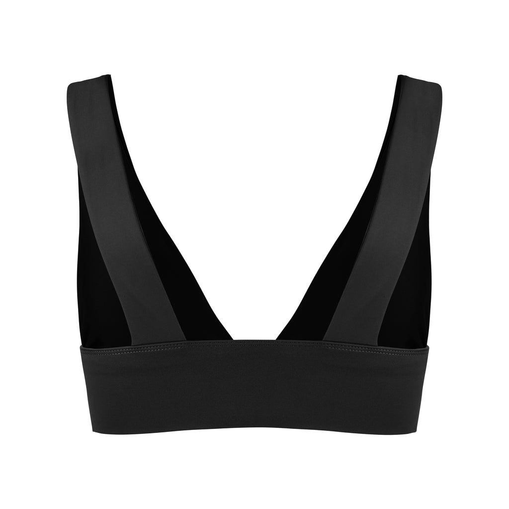 Classy and sexy sports bra in black with low-impact support, seamless fit, removable padding, and a wide under-bust elastic band ghost image back view