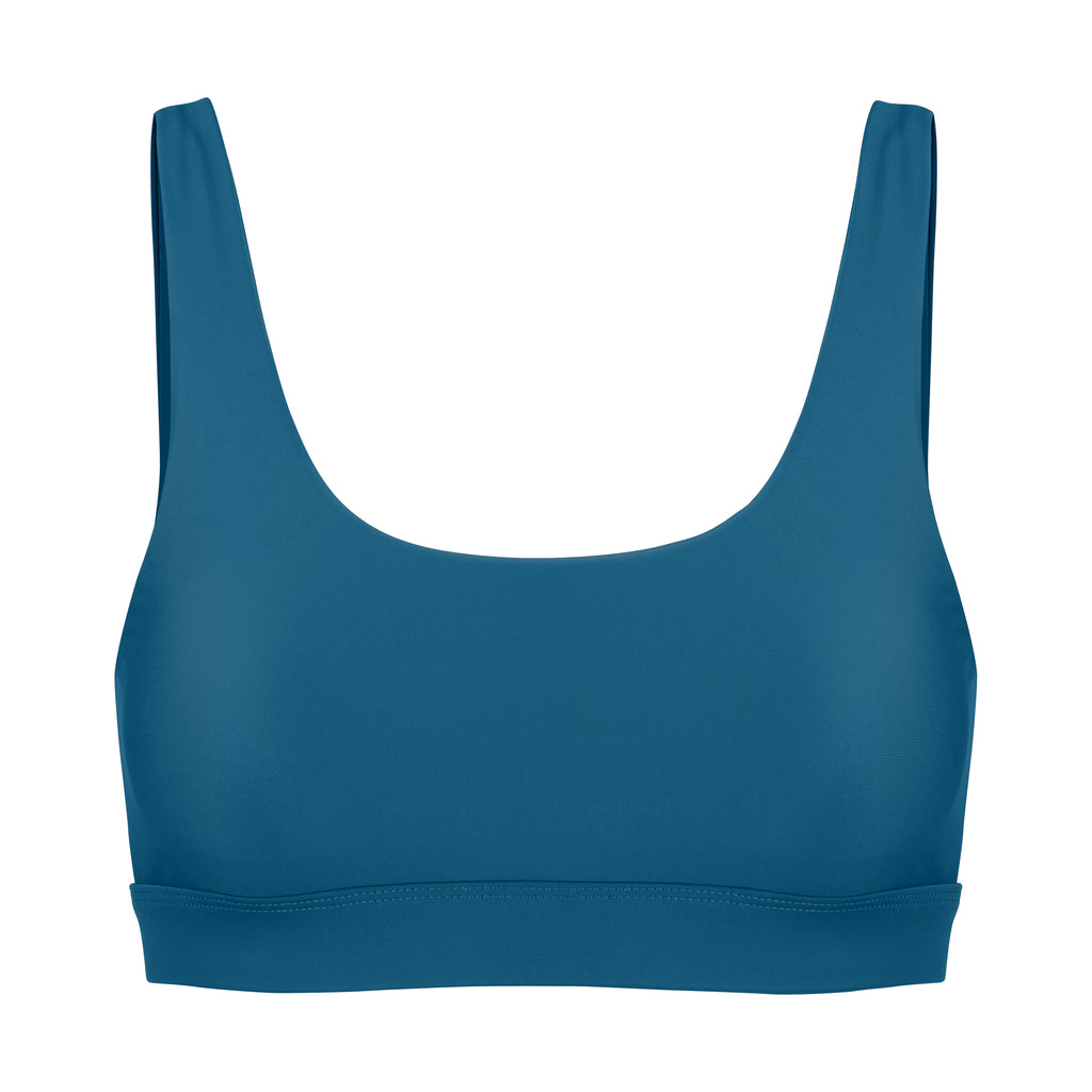 Blue classic sports bra with low to high impact support with seamless fit and removable padding, ghost image front view.