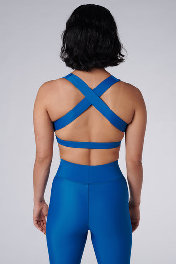 Mid Blue, medium to high impact support with removable padding, strong elastic cross back straps, and adjustable gold-hook closure back view