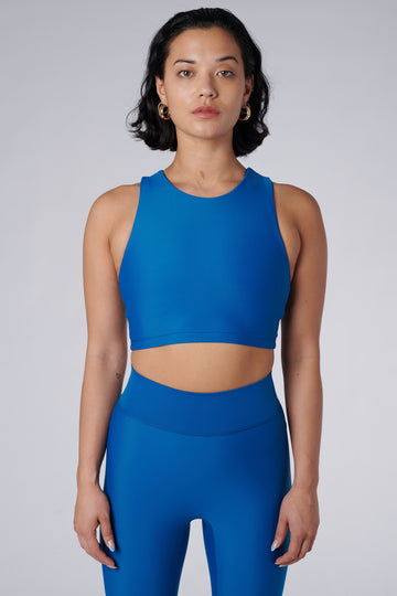 Award-winning mid blue crop top with a flattering cut, high neckline for coverage, and in-built sports bra. Medium impact support.