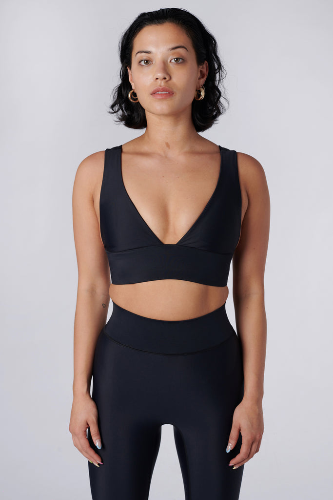 Classy and sexy sports bra in black with low-impact support, seamless fit, removable padding, and a wide under-bust elastic band front view