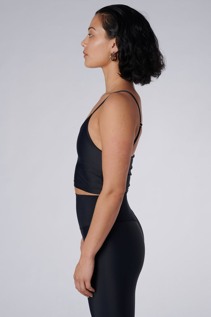 Black crop top with inbuilt bra for low-impact activities, seamless fit, removable padding, and adjustable straps. Comfortable for work or on the go, side view