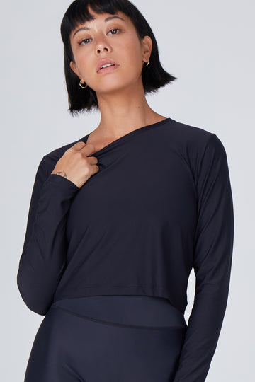 Ultra-lightweight, quick-drying long sleeve black crop top that fits like a second skin for comfort and UV protection.