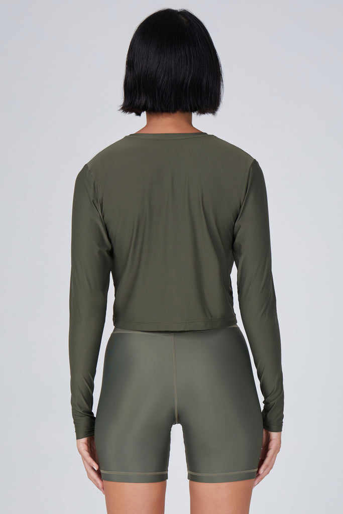 Ultra-lightweight, quick-drying long sleeve olive green crop top that fits like a second skin for comfort and UV protection back view