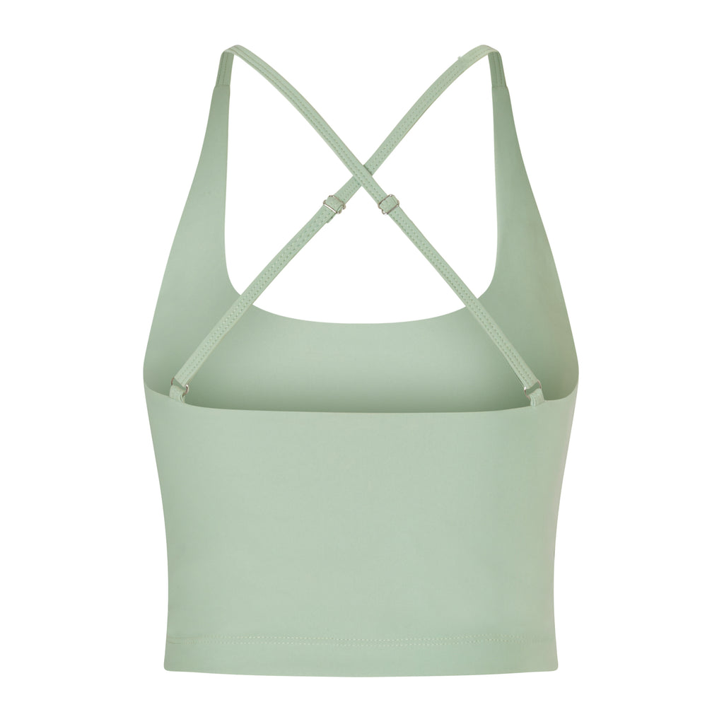 Light green seamless crop top with cross back adjustable straps, in-built sports bra, and removable padding , ghost image back view