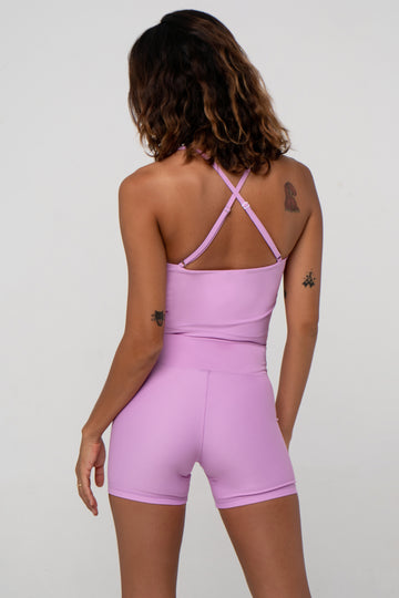 Light pink seamless crop top with cross back adjustable straps, in-built sports bra, and removable padding ,  back view