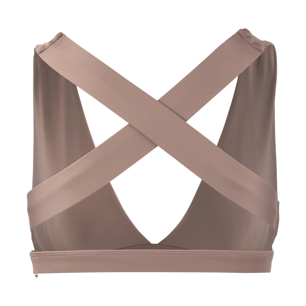 Beige, medium to high impact support with removable padding, strong elastic cross back straps, and adjustable gold-hook closure, ghost image front view