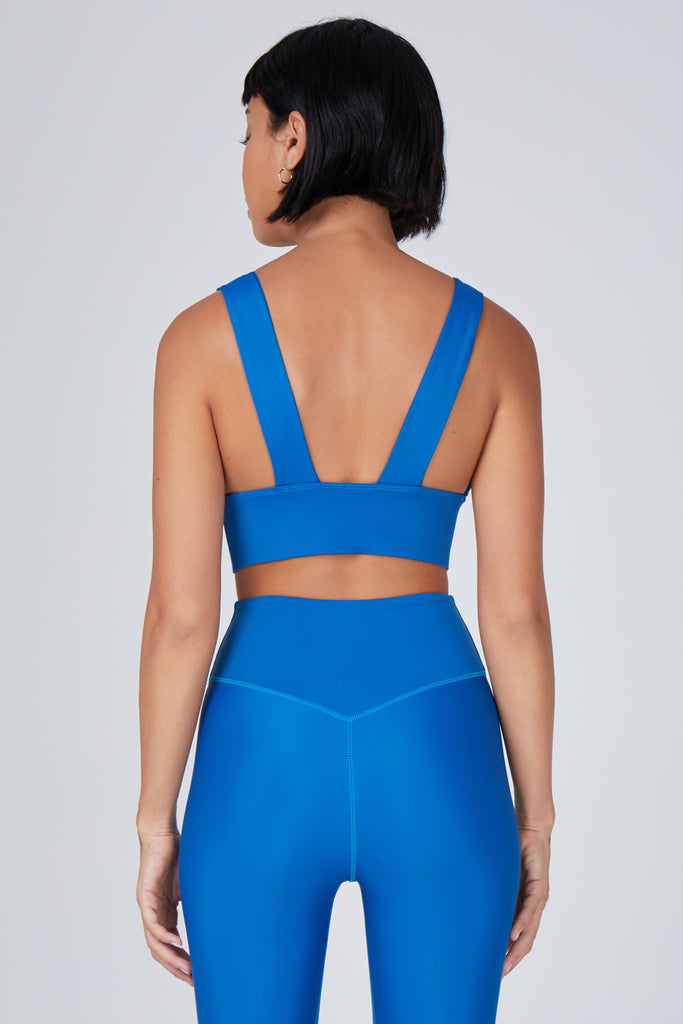 Classy and sexy sports bra in blue with low-impact support, seamless fit, removable padding, and a wide under-bust elastic band back view