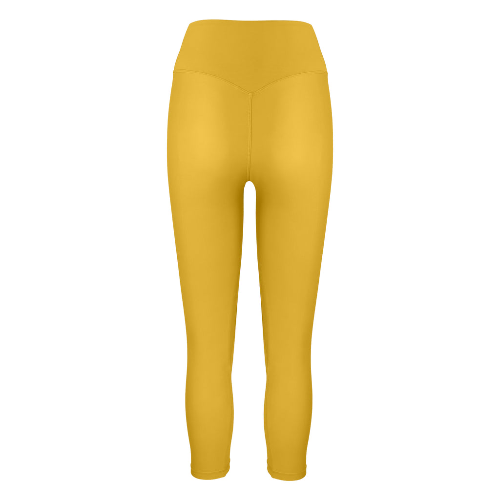 Super soft yellow high-waisted 7/8 leggings without a front seam for all-day comfort. Perfect for non abrasive sports and everyday wear, ghost image back view