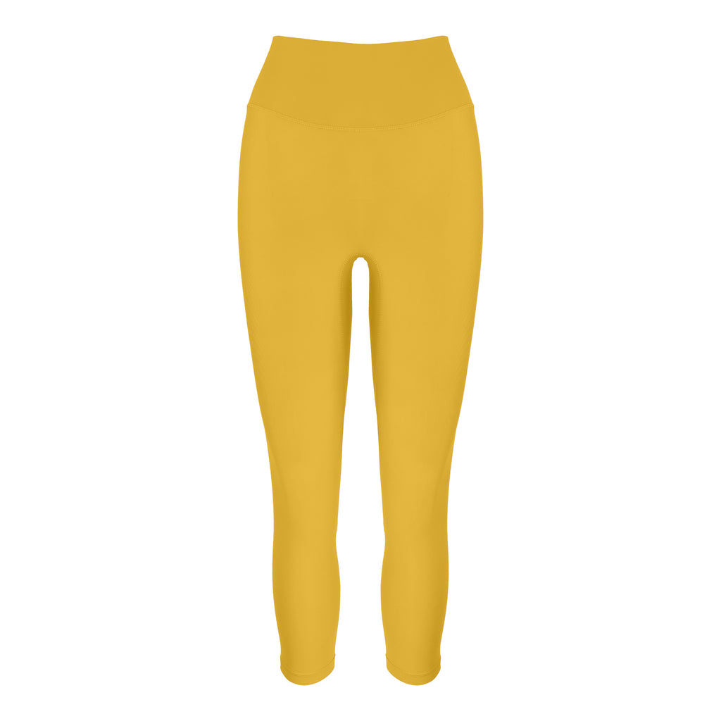 Super soft yellow high-waisted 7/8 leggings without a front seam for all-day comfort. Perfect for non abrasive sports and everyday wear, ghost image front view