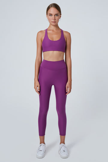 Super soft purple high-waisted 7/8 leggings without a front seam for all-day comfort. Perfect for non abrasive sports and everyday wear, front view