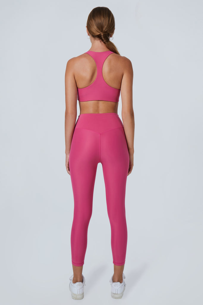 Super soft pink high-waisted 7/8 leggings without a front seam for all-day comfort. Perfect for non abrasive sports and everyday wear, back view