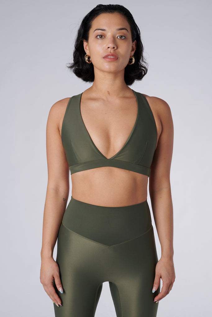 Olive green, medium to high impact support with removable padding, strong elastic cross back straps, and adjustable gold-hook closure, front view