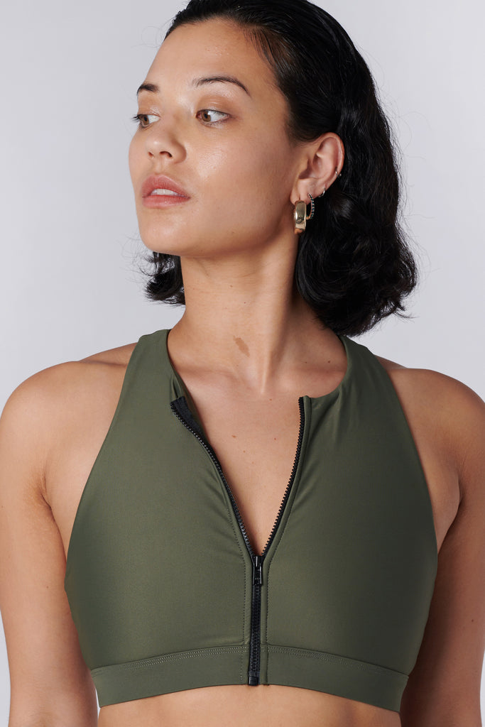 Easy to wear front zipped olive green crop top with low-impact support, removable padding and in-built sports bra, close up