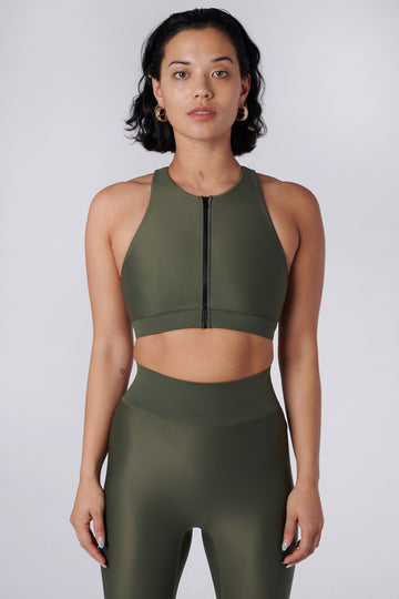 Easy to wear front zipped olive green crop top with low-impact support, removable padding and in-built sports bra, front view