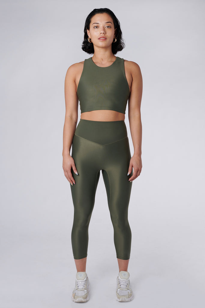 Versatile olive green 7/8 compressive leggings that fit like a glove and stay put during workouts. Squat proof and no front seam for ultimate comfort, 