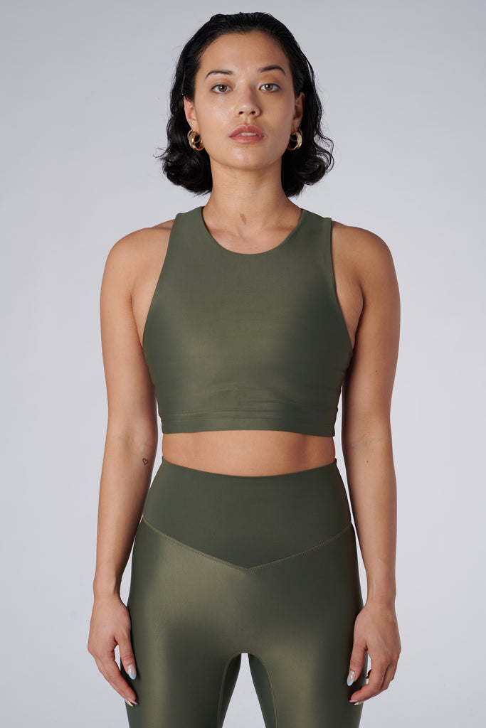 Award-winning olive green crop top with a flattering cut, high neckline for coverage, and in-built sports bra. Medium impact support, perfect for day wear