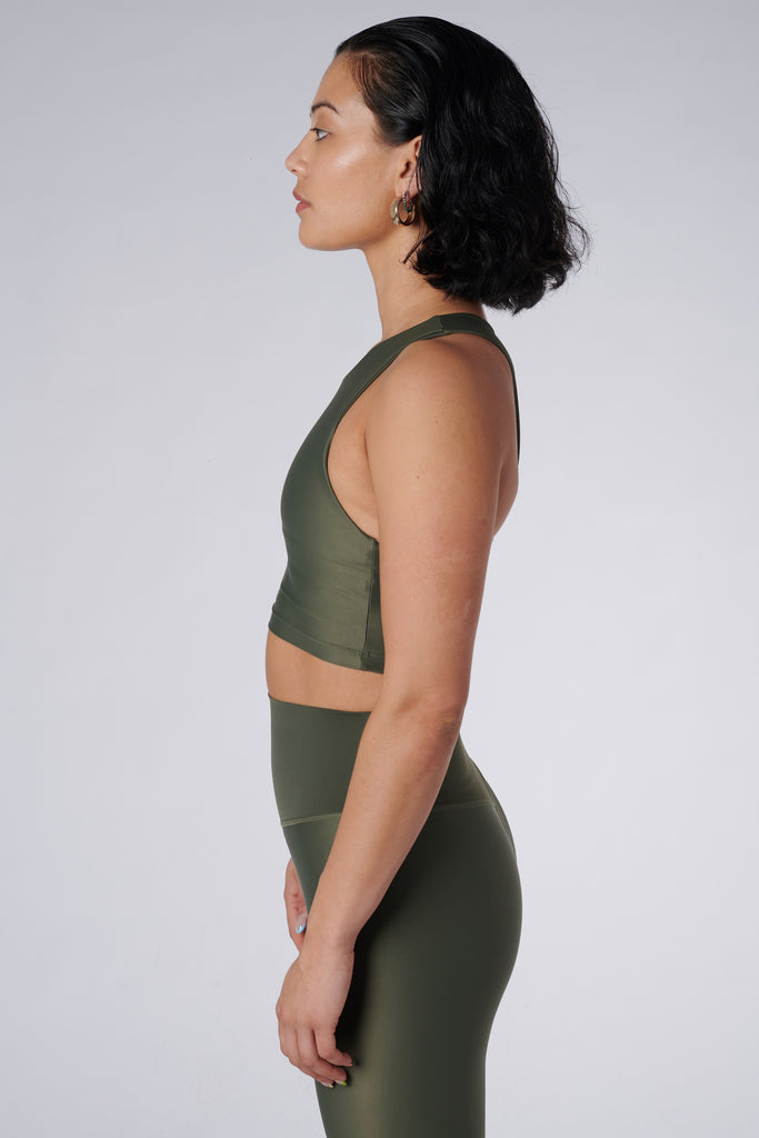 Award-winning olive green crop top with a flattering cut, high neckline for coverage, and in-built sports bra. Medium impact support, perfect for day wear, side view