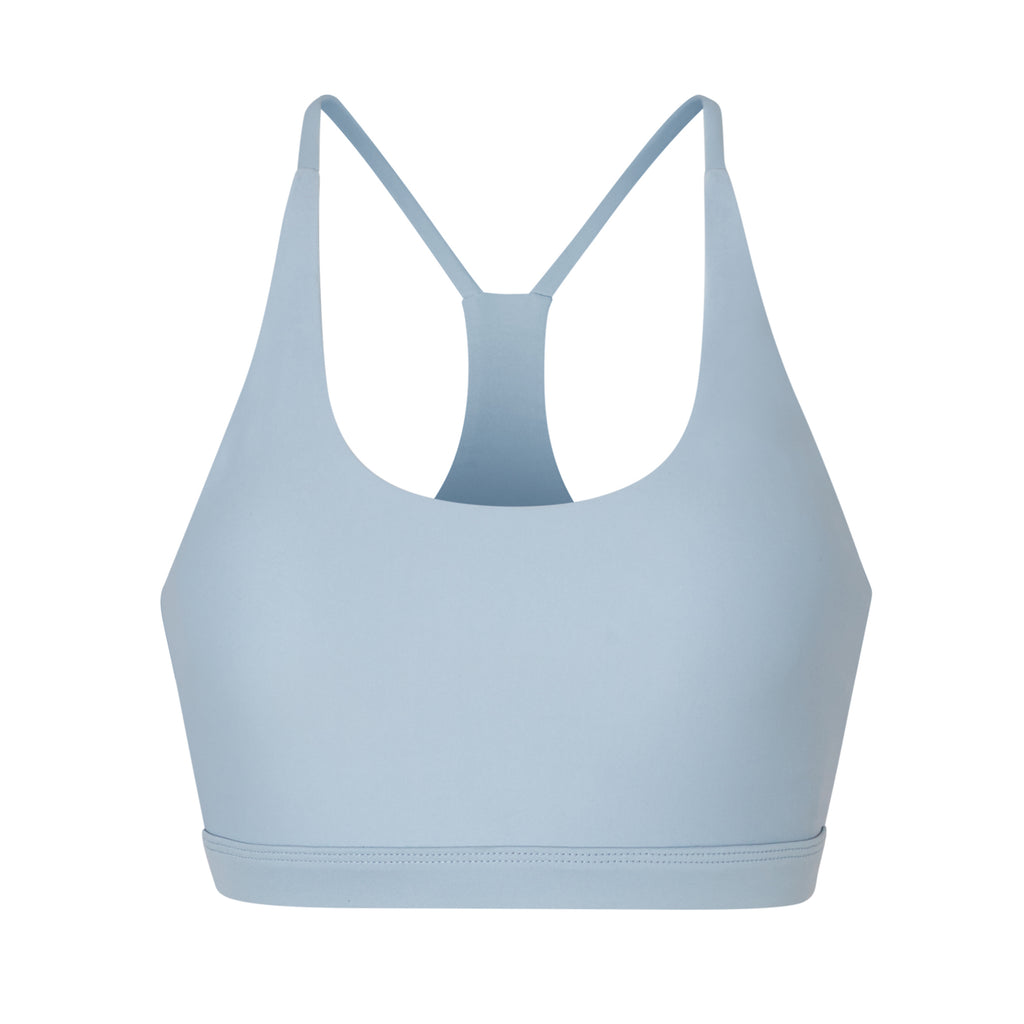 Classic racerback sports bra in light blue with seamless fit and removable padding. Perfect for light workouts and everyday wear, ghost image front view