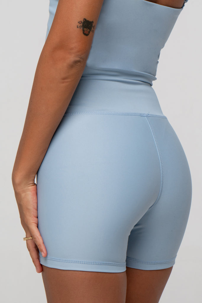 Light blue high-waisted shorts with a double-layered waistband that lies flat. No front seam for ultimate comfort and no camel toe, close up view