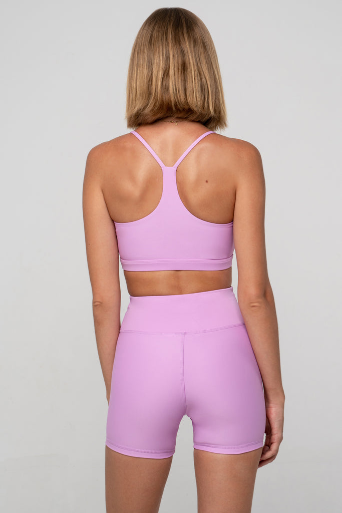 Light pink high-waisted shorts with a double-layered waistband that lies flat. No front seam for ultimate comfort and no camel toe, back view