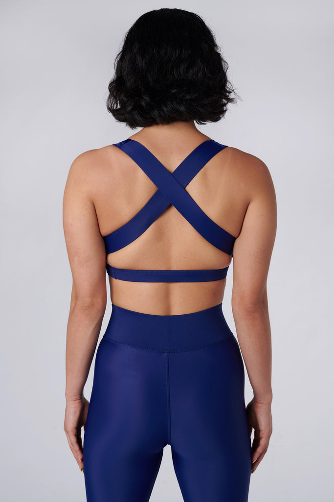 Navy blue, medium to high impact support with removable padding, strong elastic cross back straps, and adjustable gold-hook closure, back view