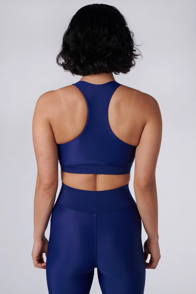 Easy to wear front zipped royal blue crop top with low-impact support, removable padding and in-built sports bra, back view