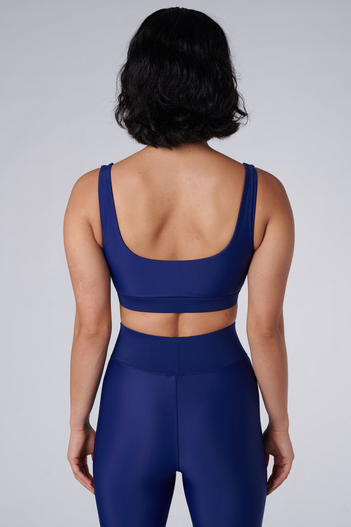 Navy blue classic sports bra with mid to high impact support, seamless fit that holds everything in place, removable padding, back view