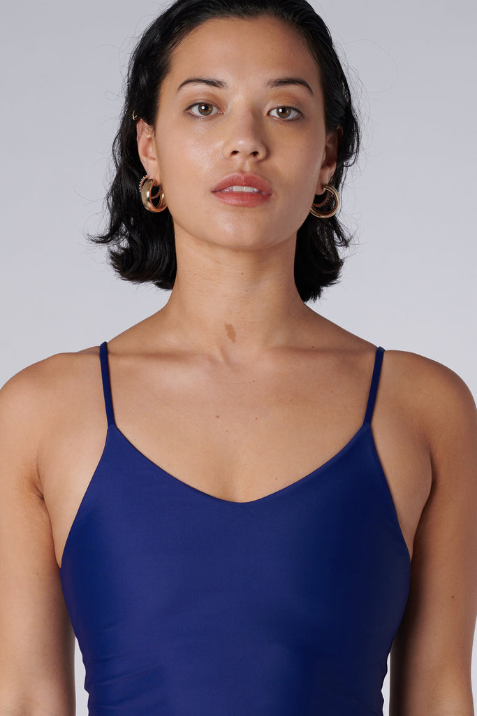 Navy blue crop top with inbuilt bra for low-impact activities, seamless fit, removable padding, and adjustable straps. Comfortable for work or on the go, close up