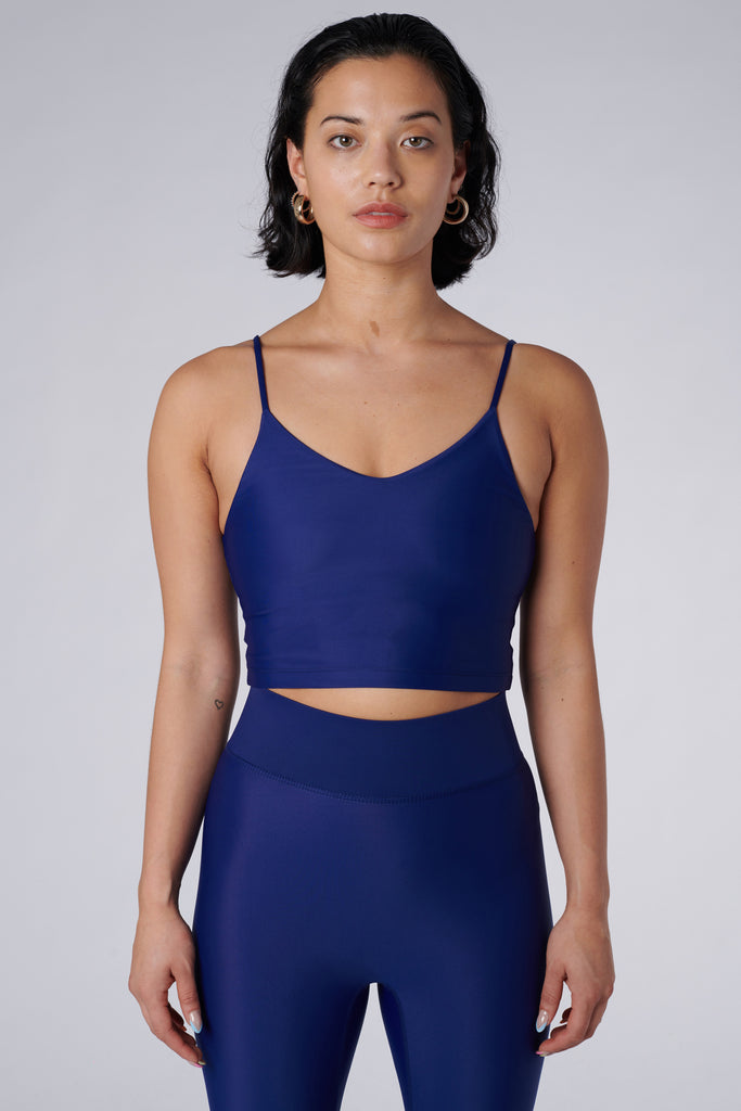 Navy blue crop top with inbuilt bra for low-impact activities, seamless fit, removable padding, and adjustable straps. Comfortable for work or on the go