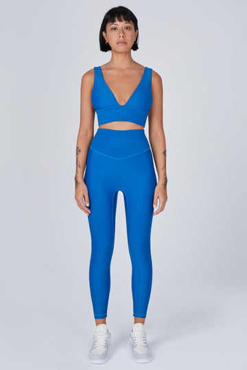 Versatile blue 7/8 compressive leggings that fit like a glove and stay put during workouts. Squat proof and no front seam for ultimate comfort.