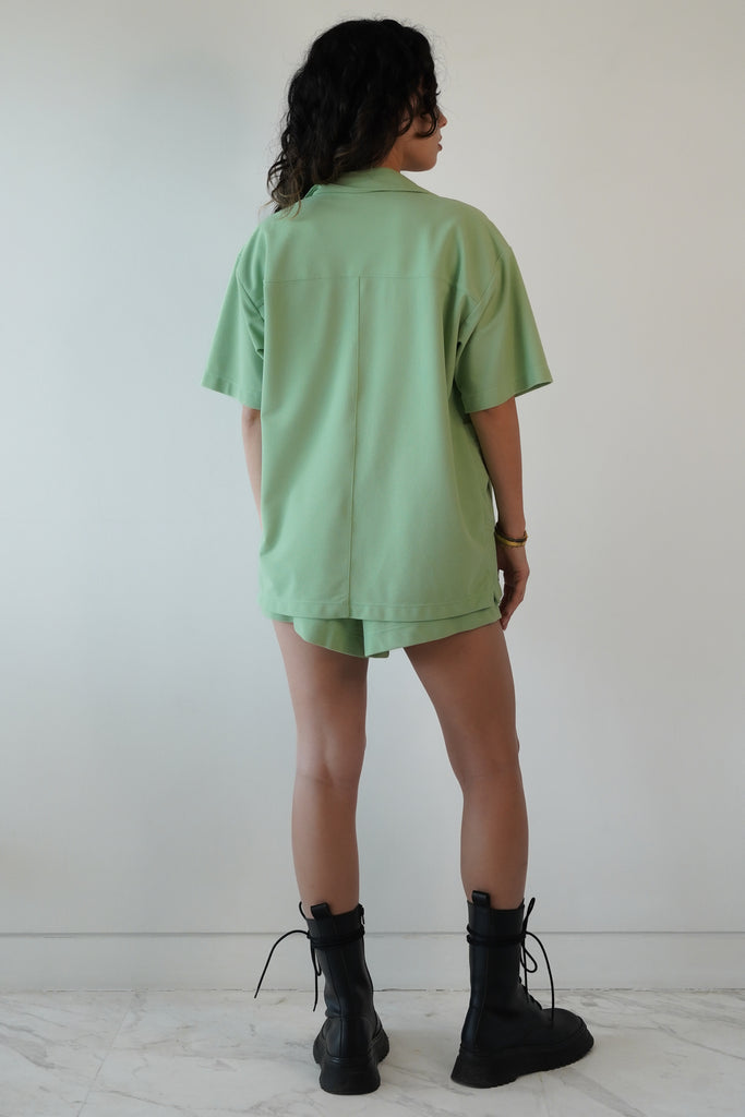 Mint green shirt in eco-friendly soft technical terry. Features coconut buttons, big pockets, and a lightweight feel, back view