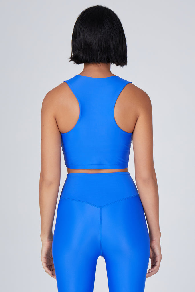 Award-winning clear blue crop top with a flattering cut, high neckline for coverage, and in-built sports bra. Medium impact support, perfect for day wear, back view