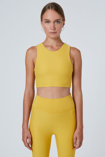 Award-winning yellow crop top with a flattering cut, high neckline for coverage, and in-built sports bra. Medium impact support, perfect for day wear