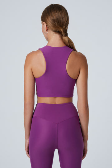 Award-winning purple crop top with a flattering cut, high neckline for coverage, and in-built sports bra. Medium impact support, perfect for day wear, back view