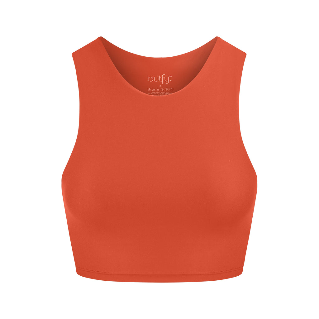 Award-winning orange crop top with a flattering cut, high neckline for coverage, and in-built sports bra. Medium impact support, perfect for day wear, ghost image front view