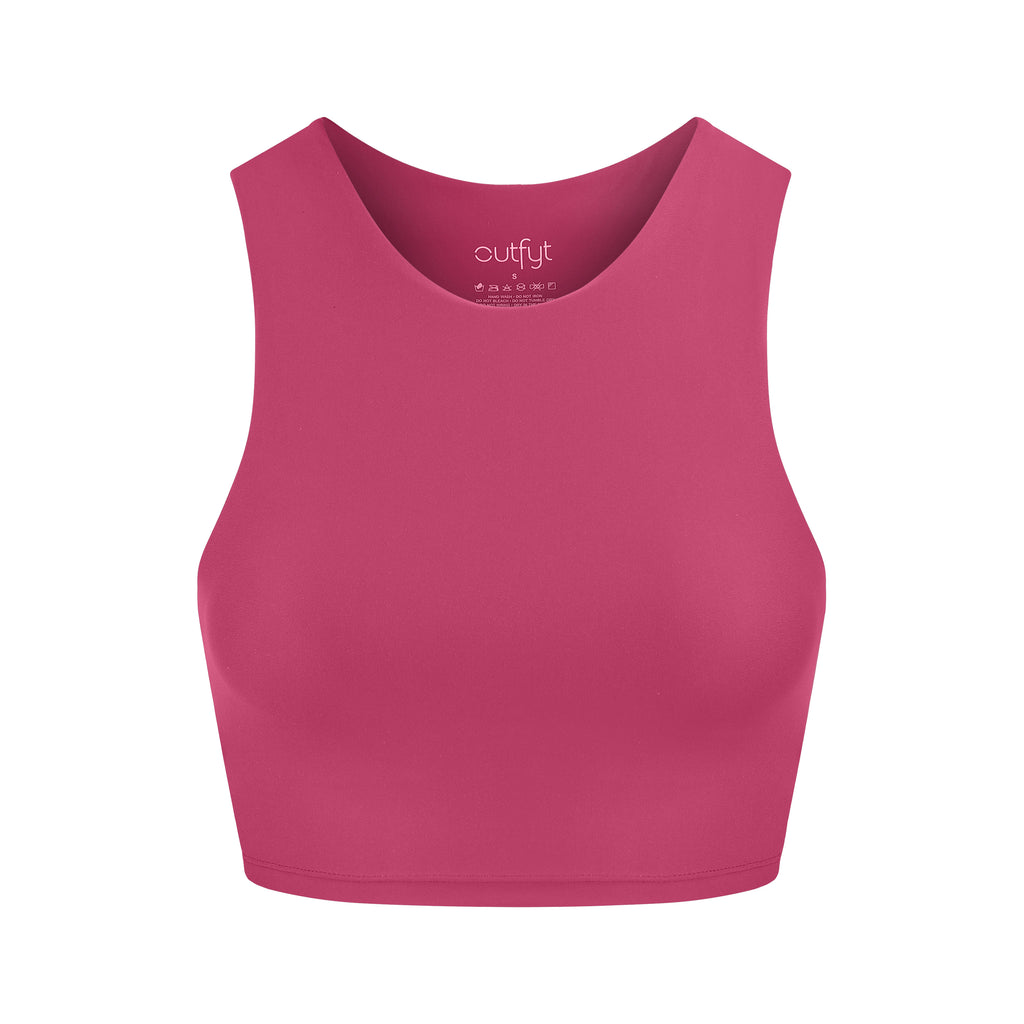 Award-winning pink crop top with a flattering cut, high neckline for coverage, and in-built sports bra. Medium impact support, perfect for day wear, ghost image front view