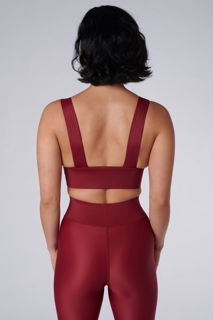 Classy and sexy sports bra in dark red with low-impact support, seamless fit, removable padding, and a wide under-bust elastic band  back view