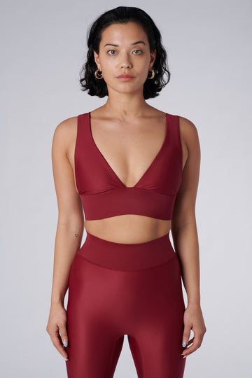 Classy and sexy sports bra in dark red with low-impact support, seamless fit, removable padding, and a wide under-bust elastic band  front view