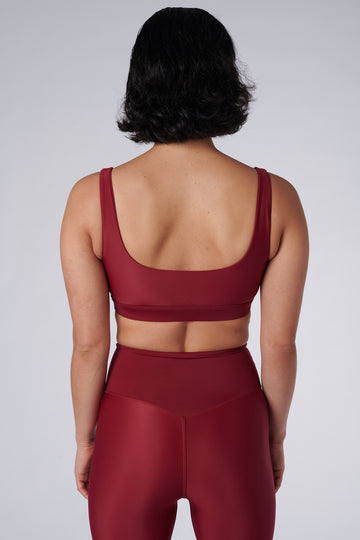 Dark red classic sports bra with mid to high impact support, seamless fit that holds everything in place, removable padding, front view