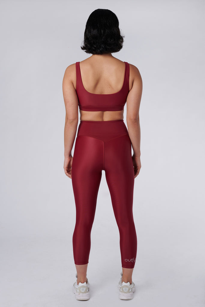 Versatile dark red 7/8 compressive leggings that fit like a glove and stay put during workouts. Squat proof and no front seam for ultimate comfort, back view