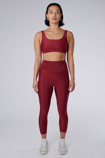 Versatile dark red 7/8 compressive leggings that fit like a glove and stay put during workouts. Squat proof and no front seam for ultimate comfort